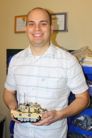 Andrew Roberts poses with a Lego M1 tank he designed and built.