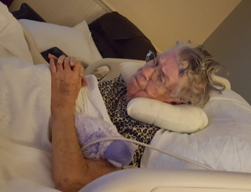 Mom watching a video of her favorite grandchild